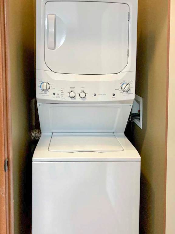A stacked washer and dryer in a laundry closet.