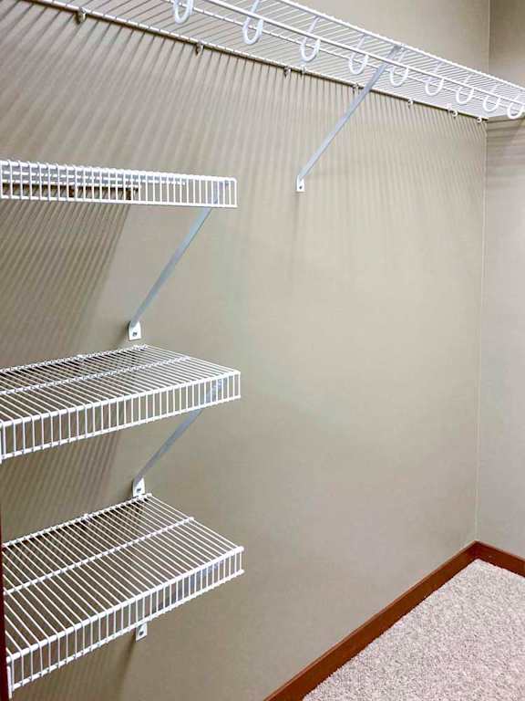 A walk-in closet with wire shelving and hanging space.