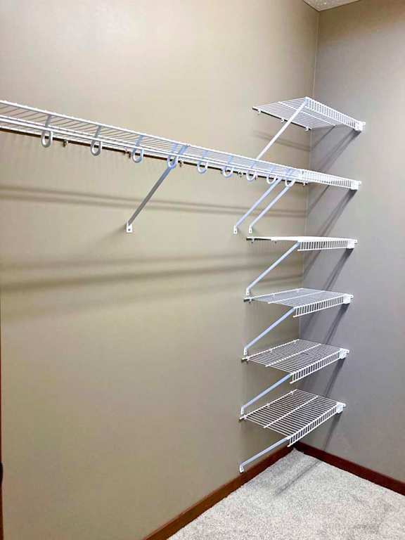 A walk-in closet with wire shelving and hanging space.