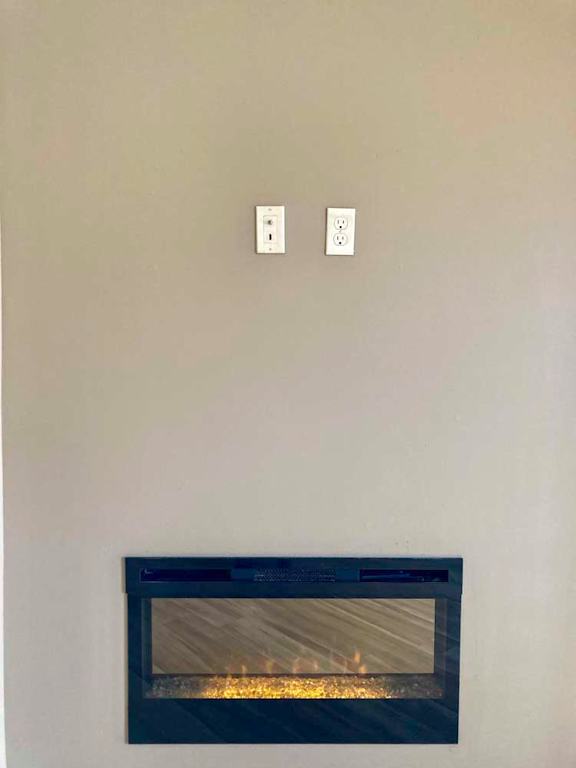 An electric fireplace with two outlets to mount a tv above.