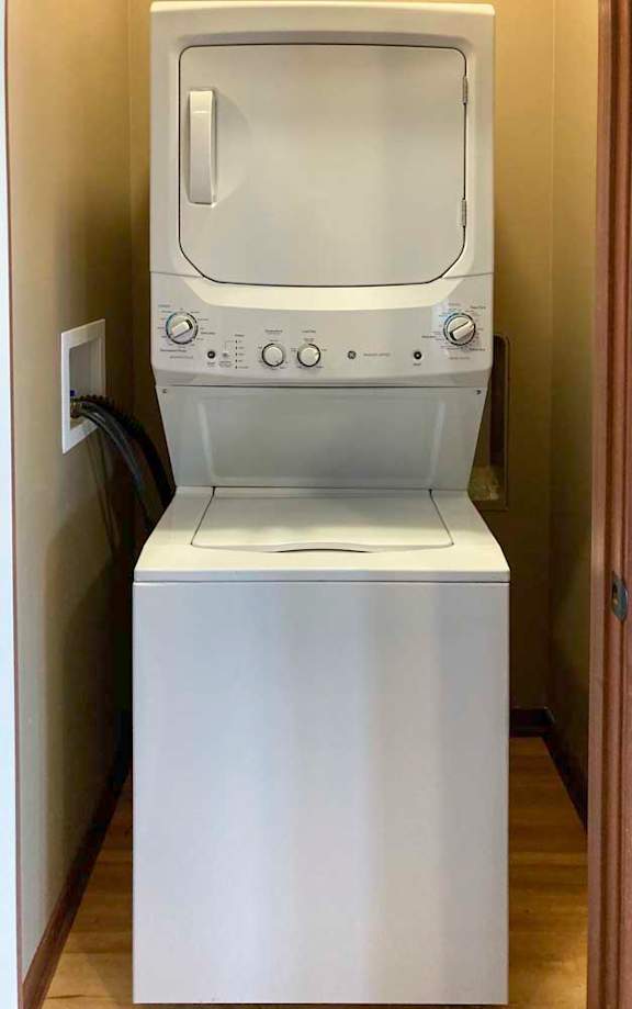 A stacked washer and dryer in a laundry closet.