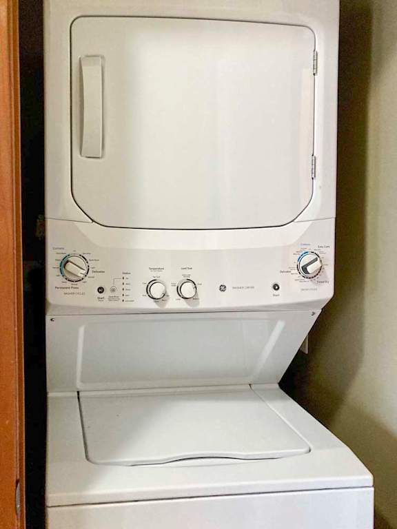 A stacked washer and dryer in a closet.