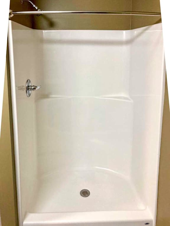 A walk-in shower with a curved curtain rod.