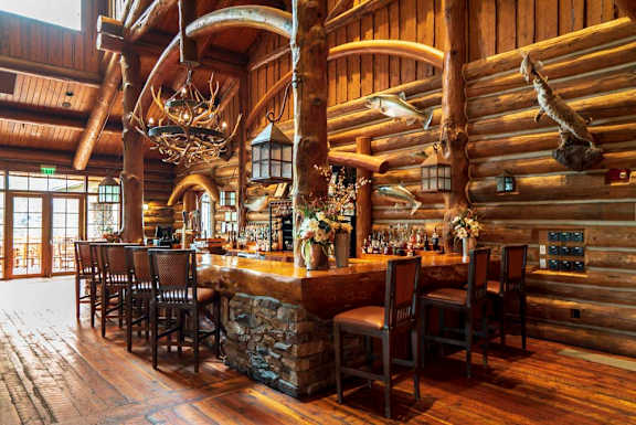 a bar inside a log cabin style restaurant