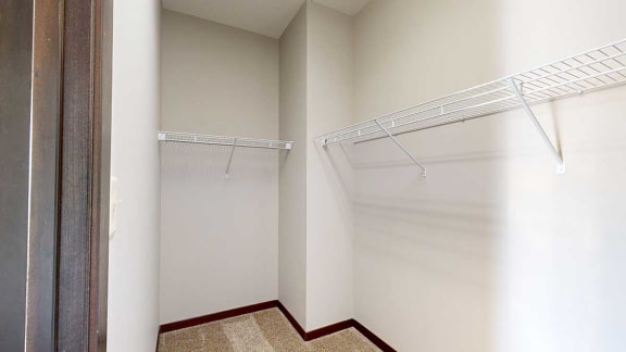a walk-in closet with built-in shelves and hanging space