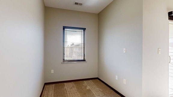 a window in a den area attached to a living room