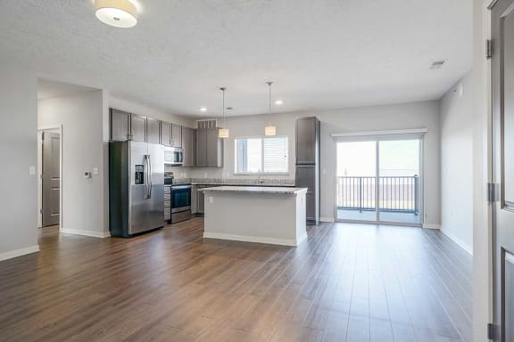 an open kitchen, dining room and living room space with luxury vinyl hardwood floors