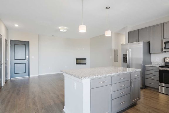 an open kitchen and living room with a large island