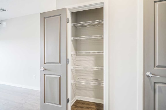 a storage pantry with built-in wire shelves