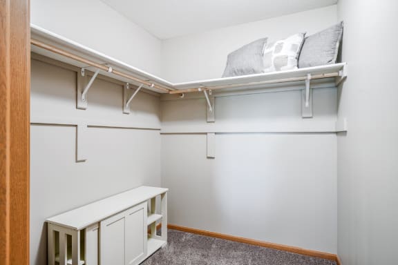 a walk in closet with shelves
