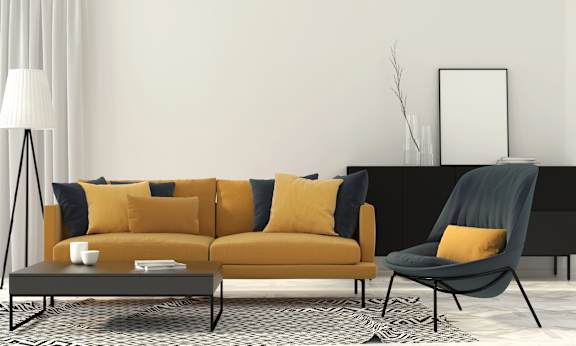 A modern living room with a yellow sofa, a grey armchair, and a black and white patterned rug.