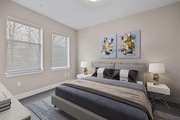 A bedroom with a large bed and two lamps.