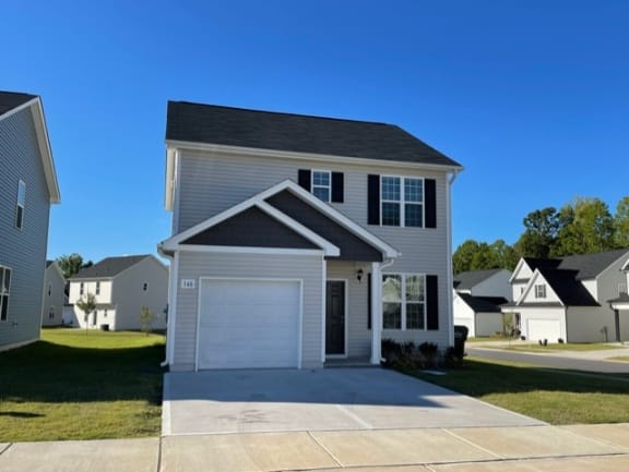 a white house with a white garage door