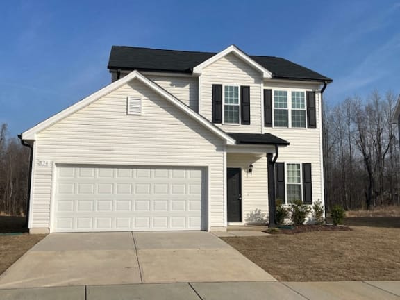 a white house with a white garage door