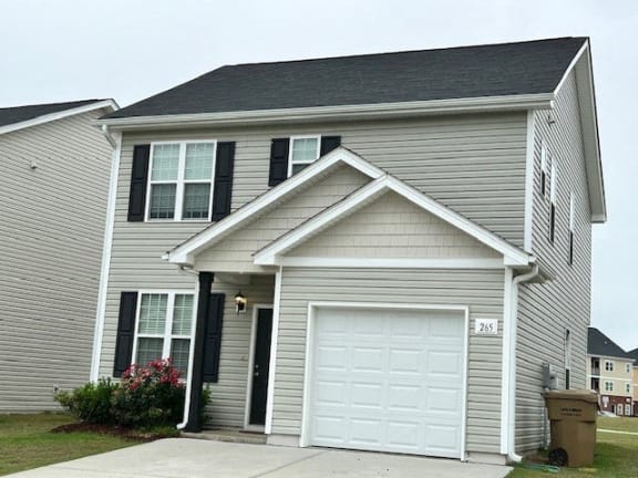 a white garage door on the side of a house