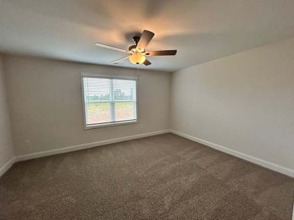 A room with a ceiling fan and a window.