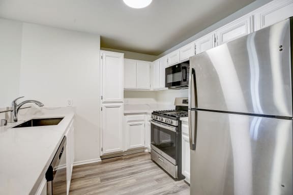 a kitchen with stainless steel appliances and white cabinets