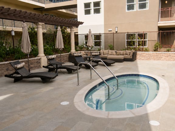 A small round pool with a ladder in the middle of it.