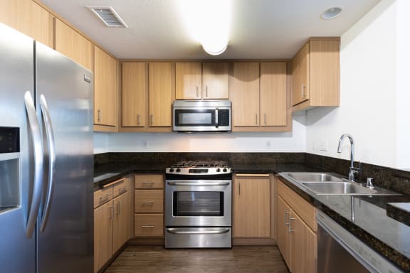 a kitchen with stainless steel appliances and wooden cabinets