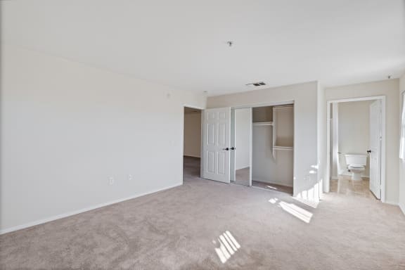 an empty living room with white walls and a bathroom  at Dronfield Astoria Apartments ,Sylmar, California