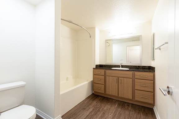 a bathroom with a toilet and a sink and a bath tub