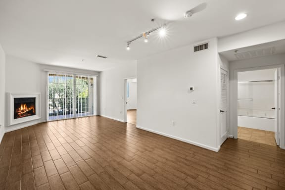 a living room with a fireplace and a wooden floor
