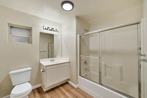 an empty bathroom with a shower toilet and sink