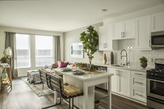 an open kitchen and living room with a table and chairs