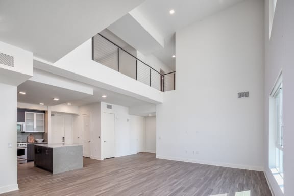 the living room and kitchen in a new home with white walls and ceilings