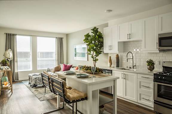 an open kitchen and living room with a table and chairs