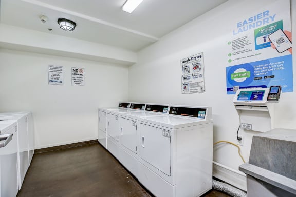 a laundry room with two washes and two washing machines
