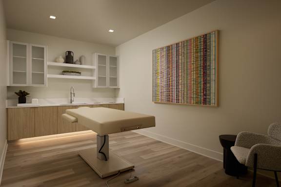 A room with a massage table and a chair.