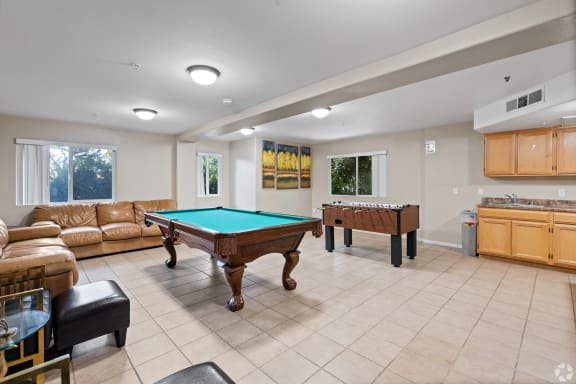 a game room with a pool table and couches at Dronfield Astoria Apartments, California, 91342