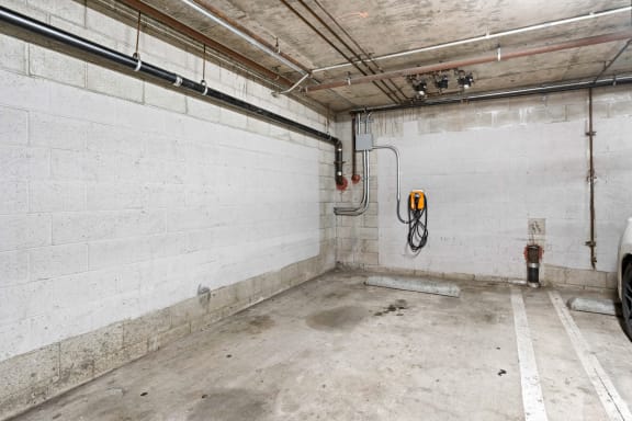 the inside of a garage with white walls and a fire hydrant at Dronfield Astoria Apartments, Sylmar, CA, 91342