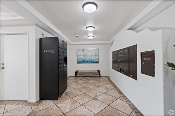 a hallway with a locker and a painting on the wall at Dronfield Astoria Apartments, California