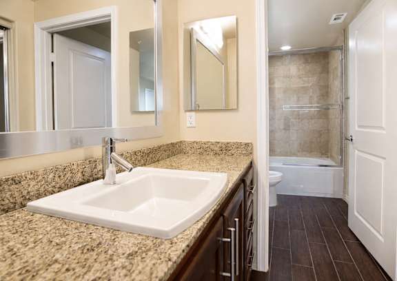 A bathroom with a sink and mirror.