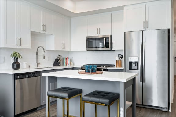 a kitchen with stainless steel appliances and a white counter top