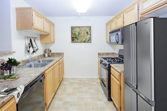 a kitchen with stainless steel appliances and wooden cabinets