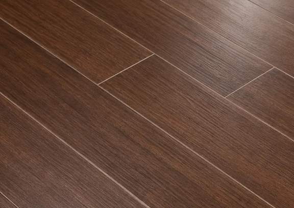 A close up of a wooden floor with a herringbone pattern.