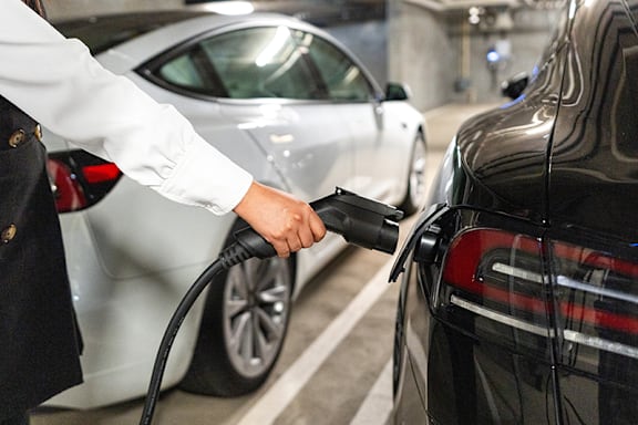 A person is charging an electric car.