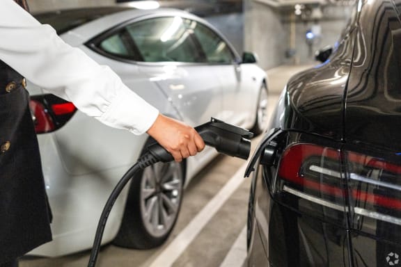a man is refueling a car at a gas station
