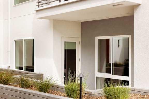 A white house with a black door and windows.