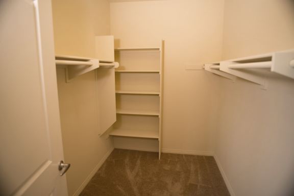A white refrigerator with a door open and a shelf in the middle.