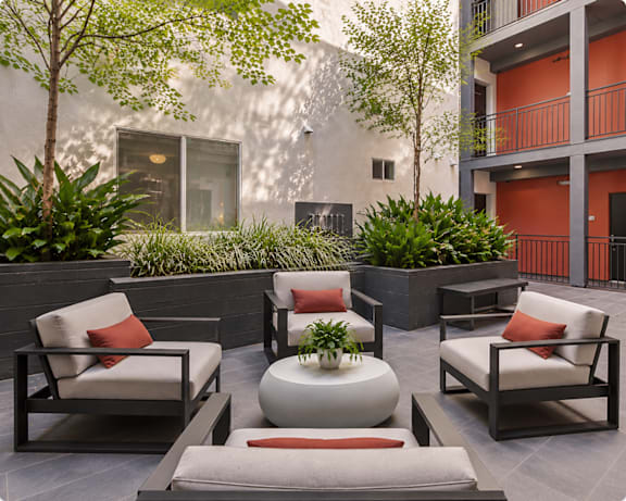 A patio with a lawn and furniture.