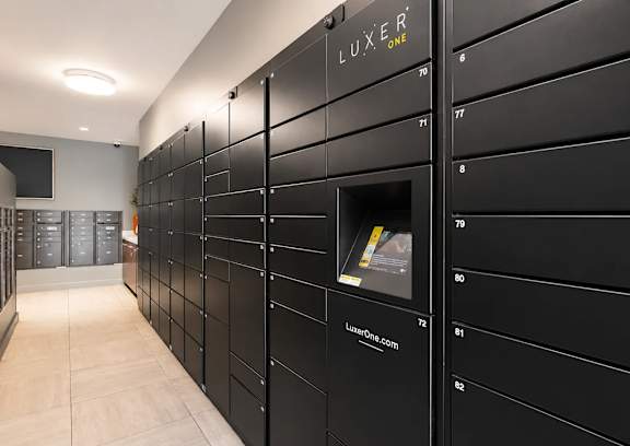 A row of black lockers with the word "LUXE" written on the top.