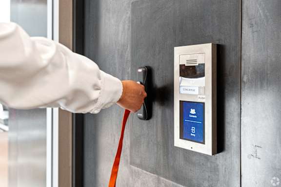 A person is pressing a button on a control panel.