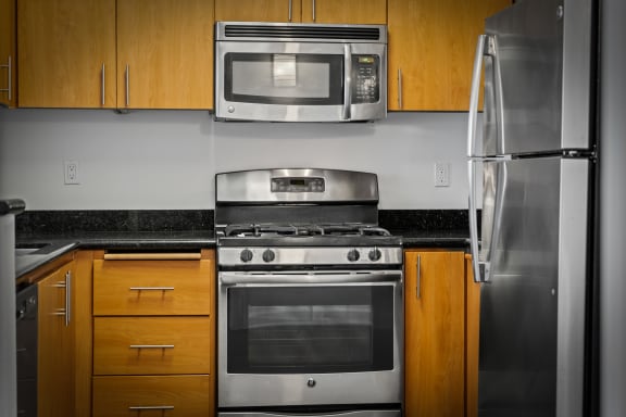 a kitchen with a stove refrigerator and microwave