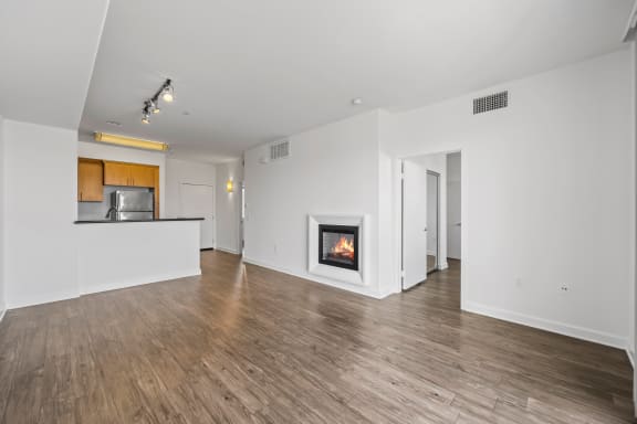 a living room with a fireplace and hardwood floors