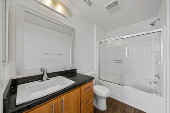 a bathroom with a sink toilet and shower