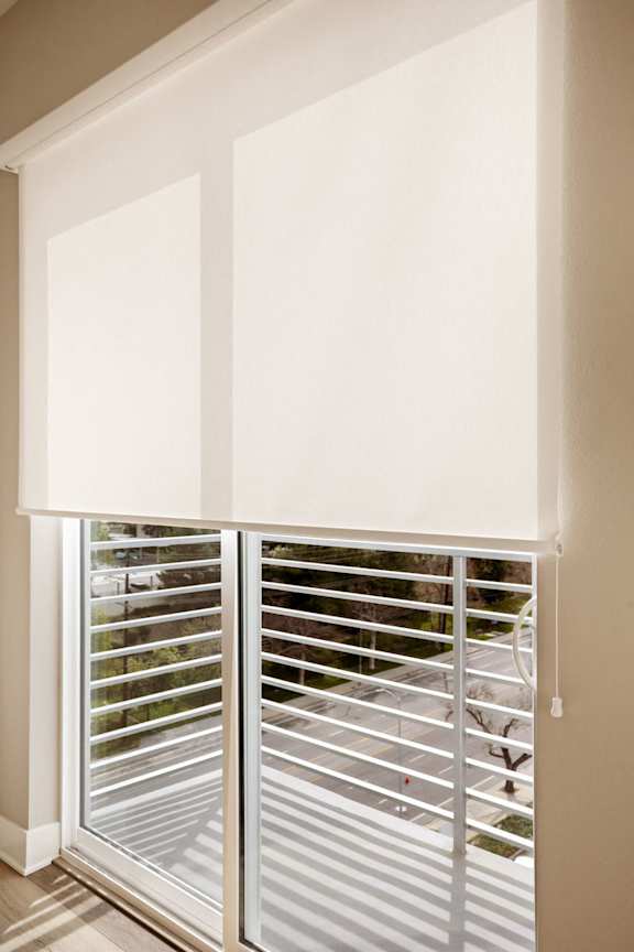 A white window with blinds is open.